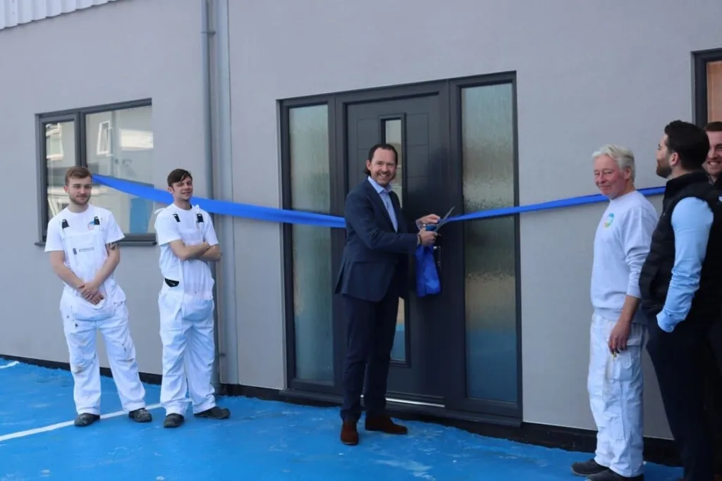 Stephen Bagnall With A Number Of Bagnalls Team Members At The Relaunch Of The Bagnalls Painting Academy In Doncaster. Stephen Is Cutting A Blue Ribbon Across The Entrance