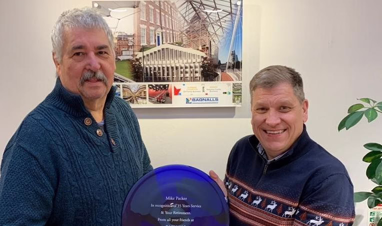 Bagnalls Team Member Mike Packer Receiving His Commemorative Plaque For Thirty-Five Years Of Service From Another Team Member