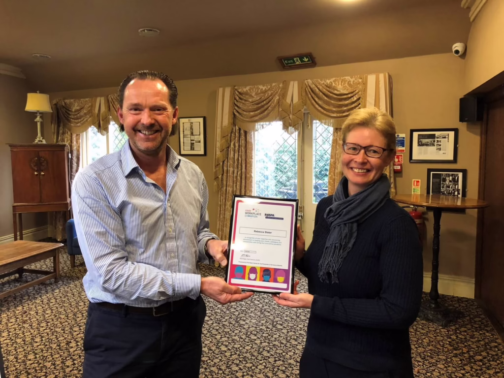 Stephen Bagnall Presenting Becky Slater With Her RoSPA Workplace Champion Framed Certificate