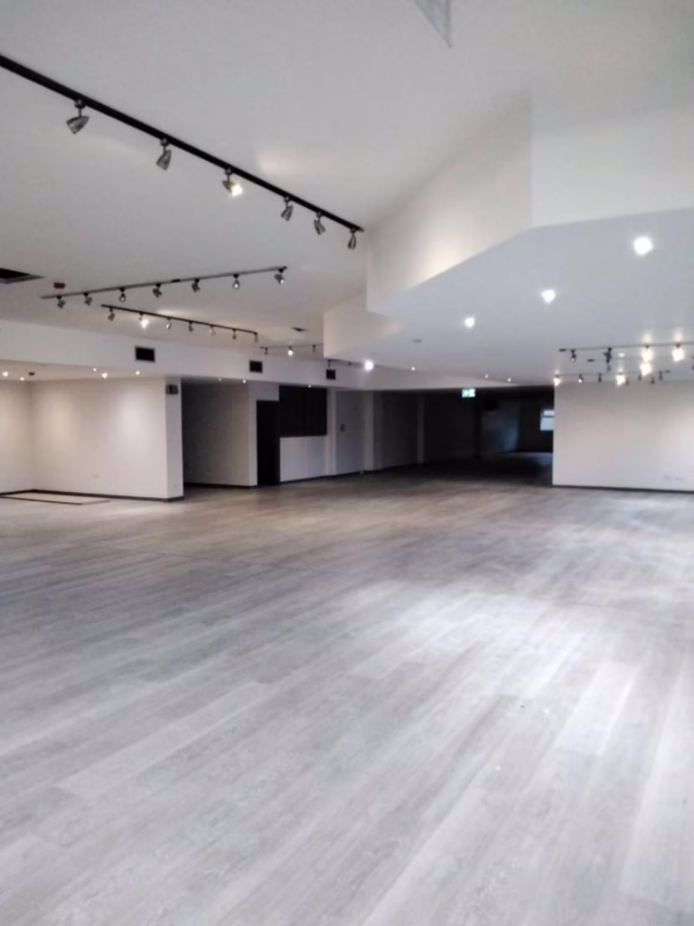 An Interior Shot Of An Empty Warehouse Painted in White