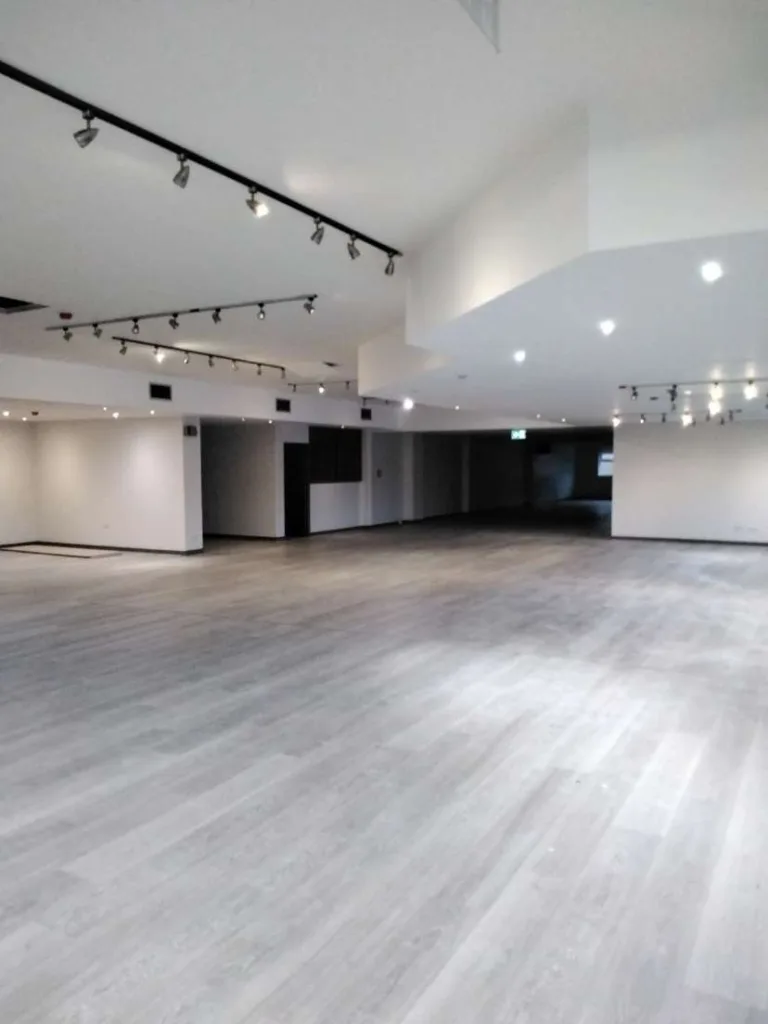 An Interior Shot Of An Empty Warehouse Painted in White