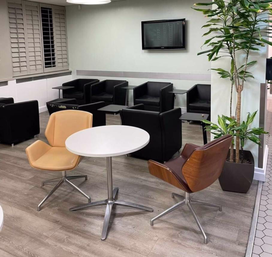 An Indoor Waiting Area With Chairs And Tables